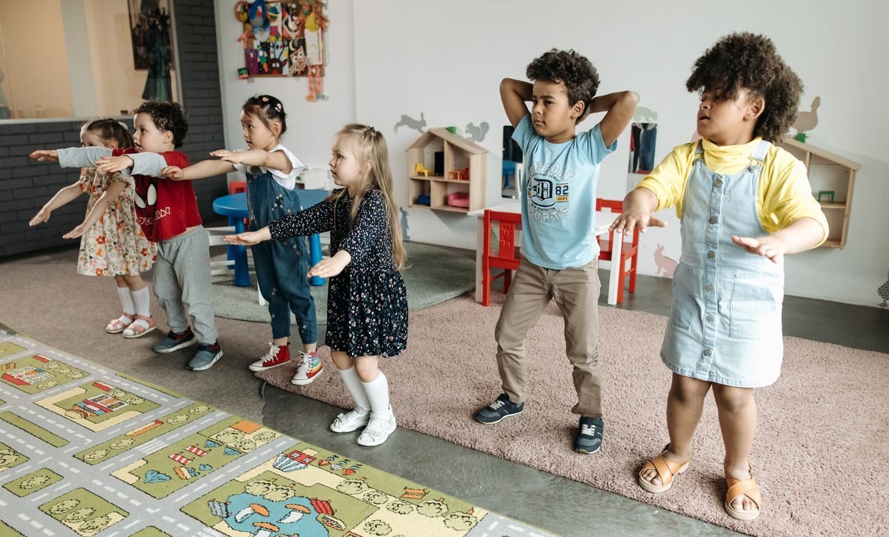 A diverse group of children participating in a fun educational activity indoors.